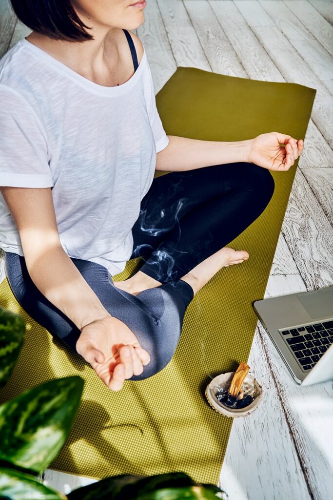 woman practicing mindfulness health and wellbeing yoga sage sticks